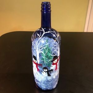 Hand painted snowmen scene on blue glass bottle